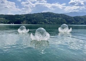 Inflatable LOTUS sculpture floating on Lake Millstatt during MillstArt 2023